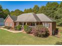 Brick house with wraparound porch and spacious yard at 946 Gaithers Rd, Mansfield, GA 30055