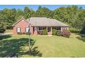 Brick home with flag, large yard, and lush landscaping at 946 Gaithers Rd, Mansfield, GA 30055
