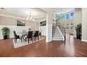 Grand foyer and dining room featuring hardwood floors, wainscoting, chandelier, and staircase at 231 Haney Rd, Woodstock, GA 30188
