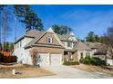 Two-story brick home with a two-car garage and landscaped yard at 231 Haney Rd, Woodstock, GA 30188