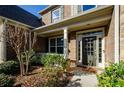 Inviting front entrance with a covered porch and charming landscaping at 231 Haney Rd, Woodstock, GA 30188