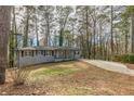 Newly renovated ranch home with gray brick exterior, modern porch, and long driveway at 1707 Boulderview Se Dr, Atlanta, GA 30316