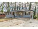 Newly renovated ranch home with gray brick exterior, modern porch, and long driveway at 1707 Boulderview Se Dr, Atlanta, GA 30316