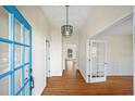 Bright entryway with hardwood floors and French doors at 450 Knoll Woods Dr, Roswell, GA 30075