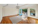 Gathering room with hardwood floors, access to the pool area at 450 Knoll Woods Dr, Roswell, GA 30075