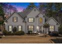 Stunning two story house with gray shutters, lit at dusk at 550 Bircham Way, Roswell, GA 30075