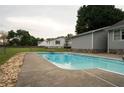 Inviting backyard pool perfect for summer fun with surrounding concrete patio and lush green grass at 309 Juanita Ln, Powder Springs, GA 30127