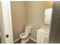 Simple bathroom with white vanity and updated toilet at 2751 Colonial Dr, College Park, GA 30337