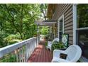 Relaxing deck with white wicker chairs and lush greenery at 4848 Green Forest Nw Ct, Acworth, GA 30102