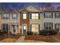 Attractive townhome facade with brick accents and teal shutters at dusk at 3712 Berkeley Xing, Duluth, GA 30096