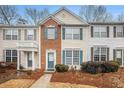 Attractive townhome facade with brick accents and teal shutters at 3712 Berkeley Xing, Duluth, GA 30096