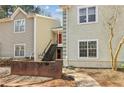 Townhome exterior with painted siding and stairs leading to entry at 64 Devon Ln, Avondale Estates, GA 30002