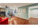 A stylish living room with hardwood floors, fireplace, furniture, and an open layout leading to the kitchen at 64 Devon Ln, Avondale Estates, GA 30002