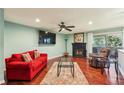 Bright living room with a fireplace, hardwood floors, ceiling fan, and a sliding glass door to the outside at 64 Devon Ln, Avondale Estates, GA 30002