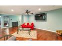 Comfortable living room with a modern ceiling fan, hardwood floors, and neutral-toned walls at 64 Devon Ln, Avondale Estates, GA 30002