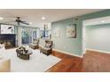 Open concept living area with a fireplace, wood floors, and access to a balcony at 64 Devon Ln, Avondale Estates, GA 30002