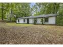 Newly renovated ranch home with white exterior, black accents, and a spacious yard at 2199 Blue Creek Ct, Conley, GA 30288