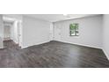 Spacious living room featuring gray walls and dark gray wood-look tile flooring at 2199 Blue Creek Ct, Conley, GA 30288