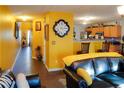 Living room features yellow walls, hardwood floors, and leather furniture at 3756 Harvest Dr, Atlanta, GA 30034
