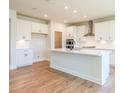 Modern kitchen with white cabinets, quartz countertops, and stainless steel appliances at 722 Crossroad Ct, Powder Springs, GA 30127
