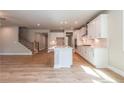 Modern kitchen with white cabinets, quartz countertops, and stainless steel appliances at 722 Crossroad Ct, Powder Springs, GA 30127