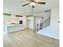 Open-concept living space featuring hardwood floors and modern staircase leading to the upper level at 722 Crossroad Ct, Powder Springs, GA 30127