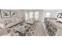 Open living space featuring a neutral color palette and modern furniture at 7410 Cranleigh St, Covington, GA 30014