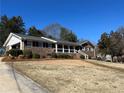 Brick ranch house with attached carport and landscaped yard at 308 Mountain Brook Rd, Cumming, GA 30040