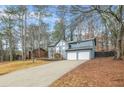 Two-story house with gray siding, a two-car garage, and a long driveway at 4006 Maxanne Nw Dr, Kennesaw, GA 30144