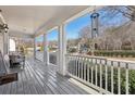 Spacious front porch with white columns and wooden flooring at 6344 Century Park Se Pl, Mableton, GA 30126