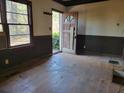 Empty living room with hardwood floors and wood paneling at 672 Rowland Rd, Stone Mountain, GA 30083