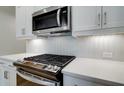 Stainless steel gas cooktop and range with white shaker cabinets at 1608 Ruskin Way, Marietta, GA 30062