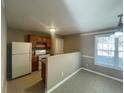 Galley kitchen with wood cabinets and white appliances at 3116 Leyland Ct, Decatur, GA 30034