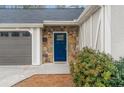 Welcoming front entry with a blue door and stone accents at 326 Scarlett Ln, Woodstock, GA 30188