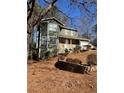 Two-story house with a stone wall and a green exterior at 5250 Mountain Village Ct, Stone Mountain, GA 30083