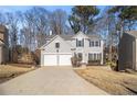 Two-story house with gray siding, white trim, and a two-car garage at 11145 Glenbarr Dr, Johns Creek, GA 30097
