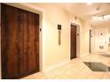 Building hallway with wood elevators and tile floors at 32 Peachtree Nw St # 1601, Atlanta, GA 30303