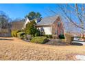 Side view of house showcasing landscaping and yard at 4901 Planters Walk, Douglasville, GA 30135