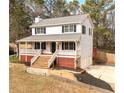 Two-story home with welcoming porch, landscaped yard and driveway at 1867 Falcon Wood Ne Dr, Marietta, GA 30066