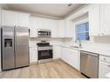 Modern kitchen with white cabinets and stainless steel appliances at 1650 Willow Way, Woodstock, GA 30188