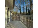 Gray deck with wooden railing overlooking wooded area at 517 Stonehedge Dr, Stone Mountain, GA 30087