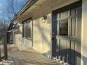 Gray front door with glass panel and wooden deck at 517 Stonehedge Dr, Stone Mountain, GA 30087