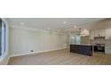 Modern kitchen with white cabinets, quartz island, and stainless steel appliances at 517 Stonehedge Dr, Stone Mountain, GA 30087