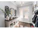 Bright entryway with console table, mirror, and double doors at 5710 Breitling Dr, Cumming, GA 30028