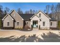 Brick house with landscaping and a light teal front door at 5710 Breitling Dr, Cumming, GA 30028