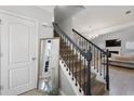 Modern staircase with wrought-iron balusters leading to the upper level at 704 Woodland Pl, Woodstock, GA 30188