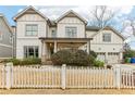 Two-story house with white siding, two-car garage, and white picket fence at 370 Park Ne Pl, Atlanta, GA 30317