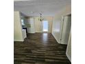 Dining room with wood-look floors and access to the kitchen at 387 Lassetter Rd, Sharpsburg, GA 30277