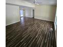 Large living room featuring dark brown wood-look flooring at 387 Lassetter Rd, Sharpsburg, GA 30277