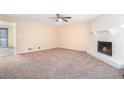 Spacious living room with a cozy fireplace and plush carpet at 4196 Jami Ln, Snellville, GA 30039